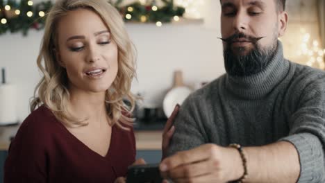 Couple-making-photos-of-Christmas-decorations