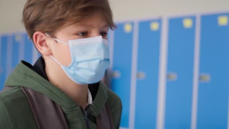 Close-up-video-of-schoolboy-in-protective-mask-the-corridor