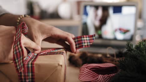 Close-up-video-of-man's-hands-packing-Christmas-present