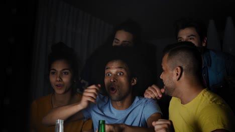 Video-of-excited-friends-watching-TV-at-night