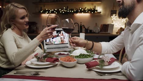 Couple-talking-with-friends-by-video-call-in-Christmas-time