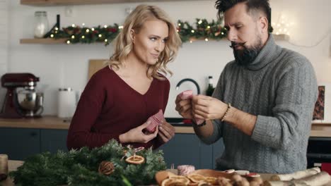 Adult-couple-making-Christmas-decorations-together