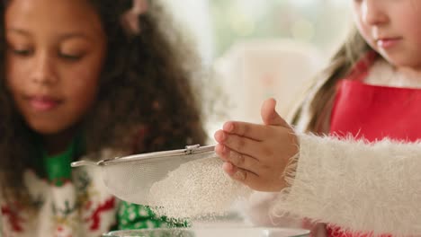 Close-up-of-little-girl-sifting-flour