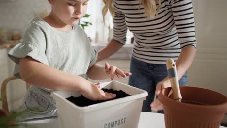 Video-of-mother-and-daughter-preparing-compost.