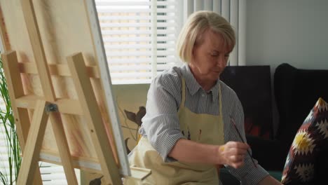Video-of-senior-artist-finishes-painting-a-picture