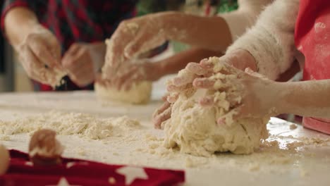 Tilt-down-view-of-family-making-cookies-together-for-Christmas