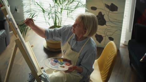 Video-of-senior-woman-enjoying-her-hobby-at-her-living-room