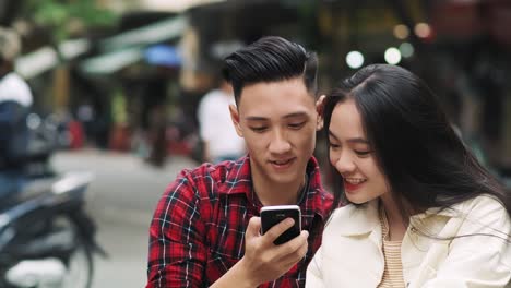 Handheld-view-of-Vietnamese-couple-making-a-selfie