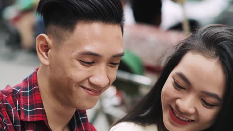 Handheld-view-of-young-Vietnamese-couple-making-a-selfie