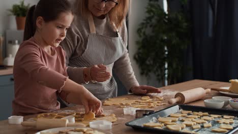 Caucasian-girl-baking-homemade-cookies-with-grandmother