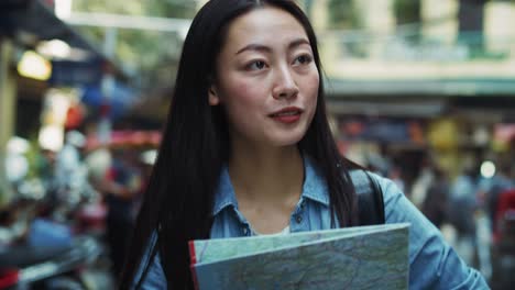 Handheld-view-of-tourist-using-map-while-sightseeing