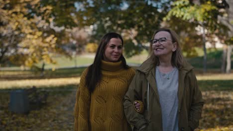 Caucasian-women-walking-together-in-park-in-autumn.