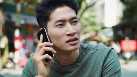 Handheld-view-of-Vietnamese-man-is-on-the-phone