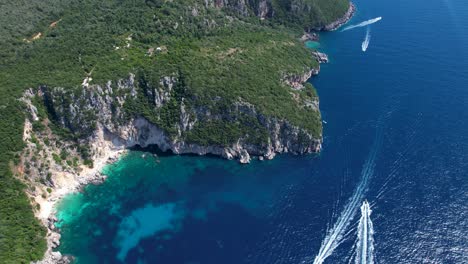 Exploring-Albania's-Secluded-Paradise:-Tourists-on-Tour-Boats-Discovering-Rocky-Shores,-Caves,-and-Unspoiled-Beaches-in-Ionian-sea