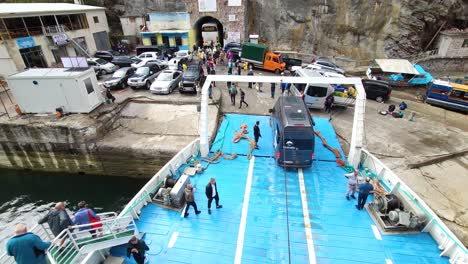 Ferry-Arrival-at-Koman-lake-in-Albania:-Passengers,-Tourists-and-Vehicles-Disembarking-from-the-Docked-Ferry-and-Heading-to-the-Station