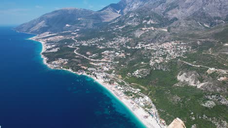 Ionian-Sea-Beauty:-Azure-Blue-Waters,-Green-Hills,-Villages,-Resorts,-and-Majestic-Mountains-Along-the-Seaside-of-Albanian-Riviera