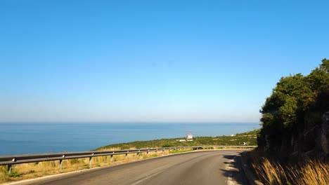 Driving-Scenic-Panoramic-Road-Meandering-Through-Albanian-Hills-with-Breathtaking-Sea-Views-and-Picturesque-Landscapes