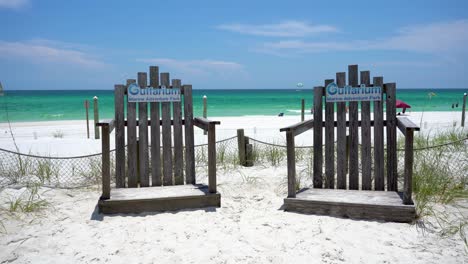 Wooden-chairs-on-the-white-sandy-beach-In-the-Gulfarium-Marine-Adventure-Park-in-Okaloosa-Island-Florida-near-Fort-walton-beach,-Destin-Florida-USA