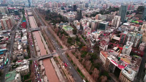 Aerial-view-establishing-the-historic-center-of-Santiago-Chile-Lastarria-neighborhood-and-the-Mapocho-river-with-great-affluence