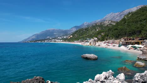 Secretly-Hidden-Beach-Paradise:-Unspoiled-White-Pebbles,-Turquoise-Waters,-and-Cliffs-in-Albania-for-a-Perfect-Summer-Vacation