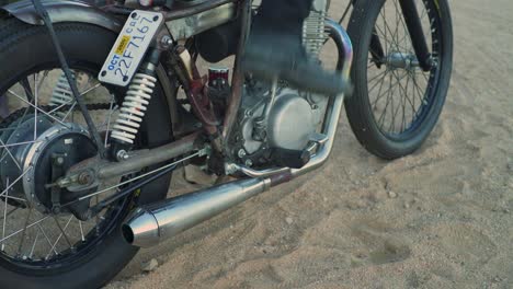 Mann-In-Hohen-Schwarzen-Stiefeln-Startet-Vintage-Retro-Chopper-Motorrad-In-Der-Wüste