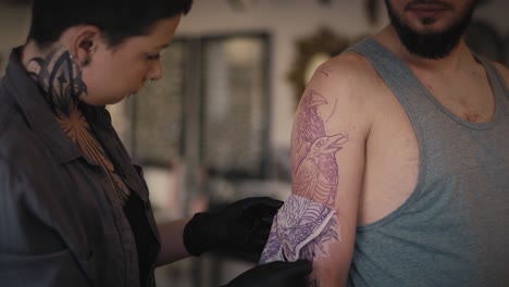 Caucasian-woman-preparing-to-making-tattoo-for-her-customer.