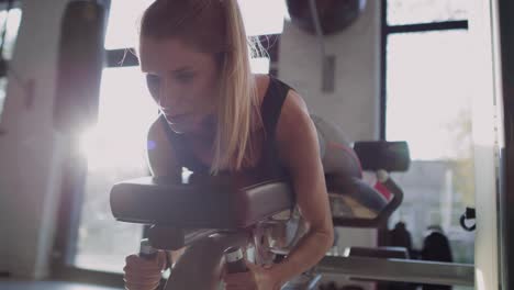 Handheld-view-of-woman-during-hard-workout-in-the-gym