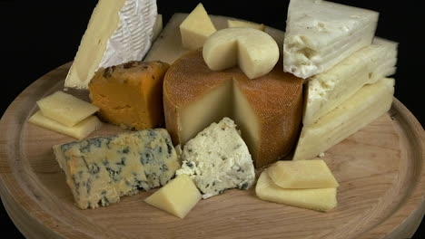 Cheese-platter:-Sharp,-subtle,-hard,-soft-cheeses-rotate-on-wood-board