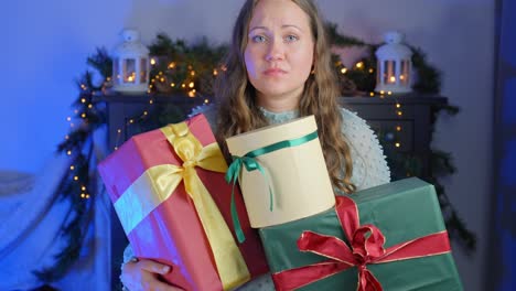 Woman-feeling-unhappy-over-gifts-she's-holding-towards-camera,-static-closeup