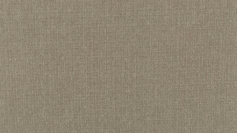 A-Slow-Zoom-In-Closeup-Shot-of-Beige-Brown-Wool-Polyester-Upholstery-Texture-Finish-Surface-Weave-Pattern-Fabric-On-a-Sofa-Love-Seat-Sectional-Furniture-Item-Background