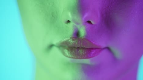 Extreme-close-up-shot-of-a-beautiful-woman's-lip-as-she-presses-her-lips-together-to-spread-her-newly-applied-lipstick-after-getting-ready-for-club-night-evenly-in-slow-motion