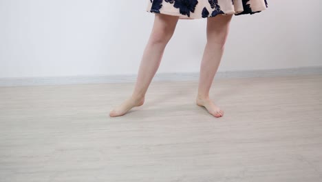 Bare-feet-on-a-young-and-attractive-female-dancer-dancing-in-a-white-room