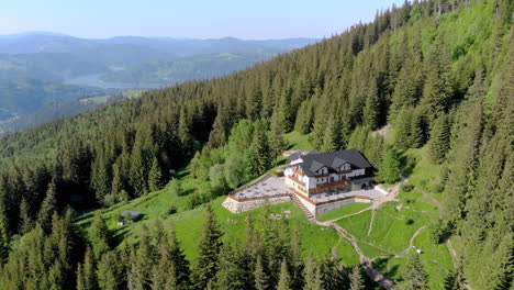 Cabin-in-the-woods,-aerial-view,-Ceahlau-National-Park