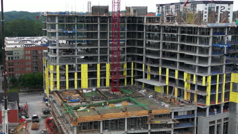 Aerial-slide-and-pan-shot-of-extensive-construction-site-of-modern-tall-apartment-building