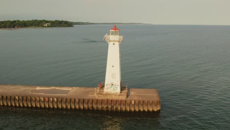 Static-Drone-view-of-the-small-light-house-and-water-at-Sodus-point-New-York-vacation-spot-at-the-tip-of-land-on-the-banks-of-Lake-Ontario