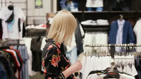 Young-woman-during-big-shopping-in-the-clothes-store