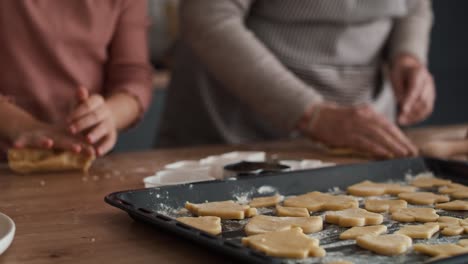 Caucasian-girl-baking-homemade-cookies-with-grandmother.