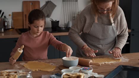 Caucasian-girl-preparing-homemade-cookies-with-grandmother