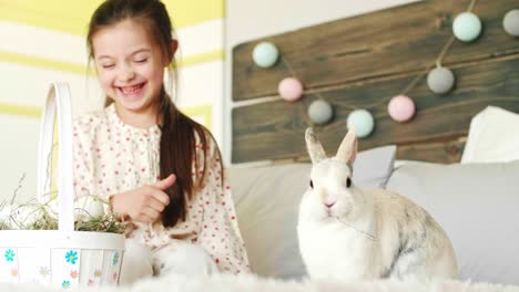 Smiling-girl-feeding-the-rabbit