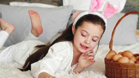 Playful-girl-putting-eggs-in-the-easter-basket