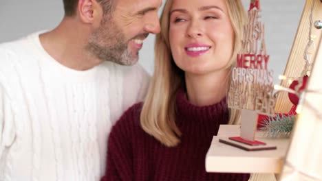 Smiling-man-embracing-his-girlfriend-in-Christmas