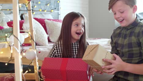 Happy-siblings-opening-christmas-present