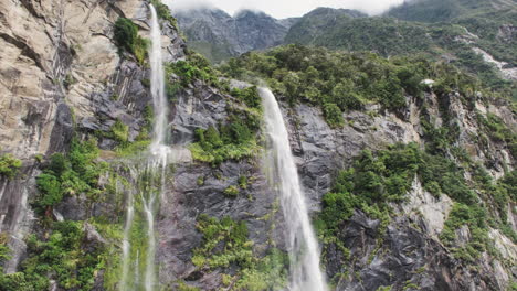Majestic-misty-waterfalls-cascade-down-steep-rocky-cliffs