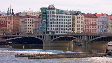 Dancing-House-and-Jirásek-bridge-over-Vltava-river-in-Prague-city