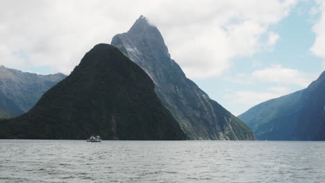 A-ship-appears-minuscule-against-the-breathtaking-expanse-of-Milford-Sound