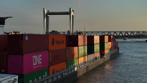 Goods-on-container-vessel-sailing-along-the-Oude-Mass-river-at-Dordrecht,-Netherlands