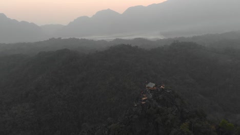 Flying-around-famous-viewpoint-near-vang-vieng-Laos-with-sunrise,-aerial