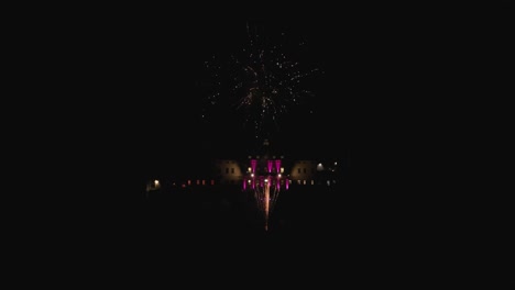 cinematic-aerial-drone-shot-of-orbit-around-beautiful-fireworks-at-night-with-old-big-italian-villa-lodge-country-house-in-background
