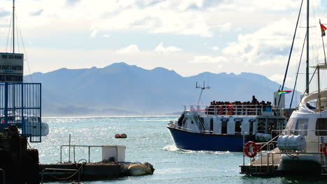 Whale-watching-vessel-packed-with-tourists-navigate-out-of-Hermanus-New-Harbour
