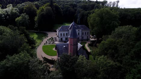 A-magnificent-renovated-castle-in-the-middle-of-its-forest,-with-its-fountain-and-chapel